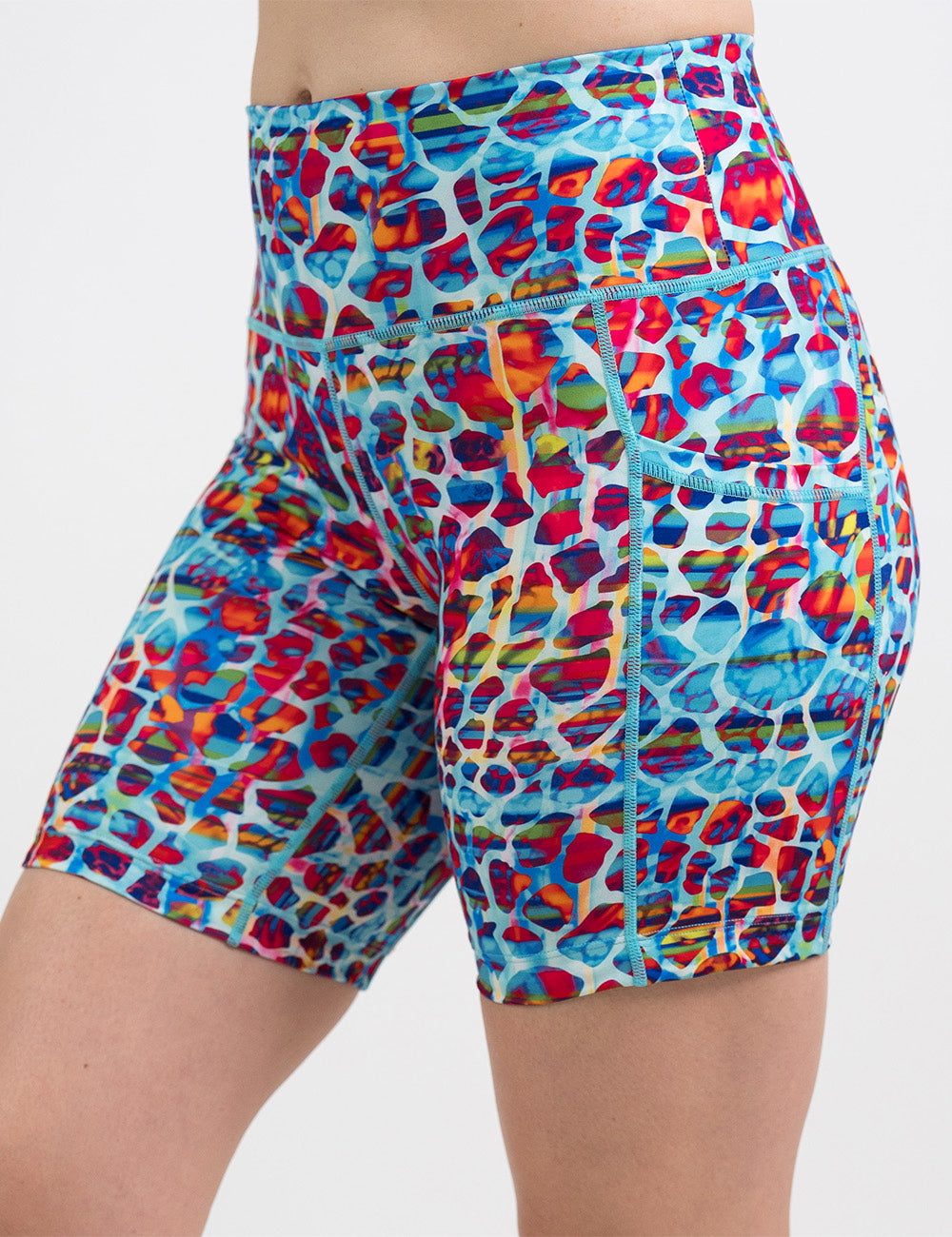 front of the 7 inch red, teal, and yellow mosaic style shorts against a white background