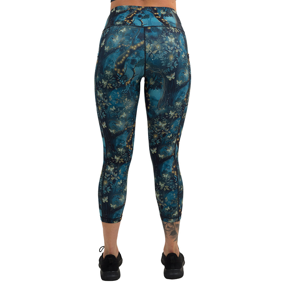 back of the forest filled with firefly's pattern capri leggings against a white background