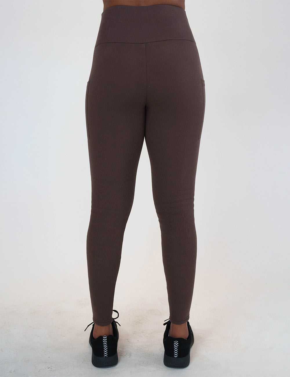back of the solid brown fleece lined leggings against a white background
