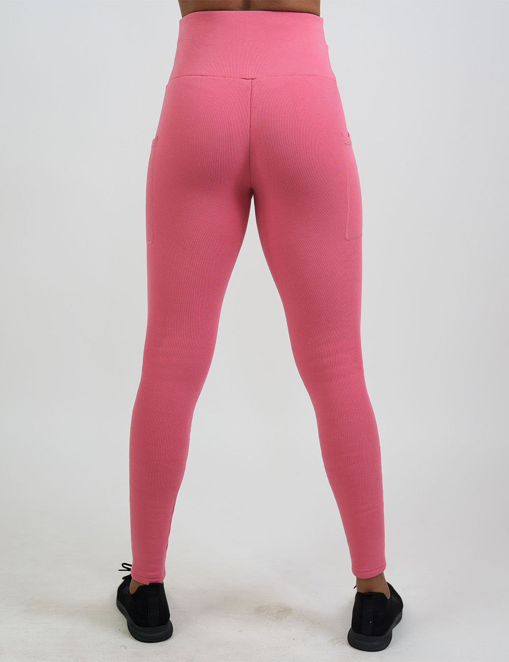 back of the solid pink fleece lined leggings against a white background