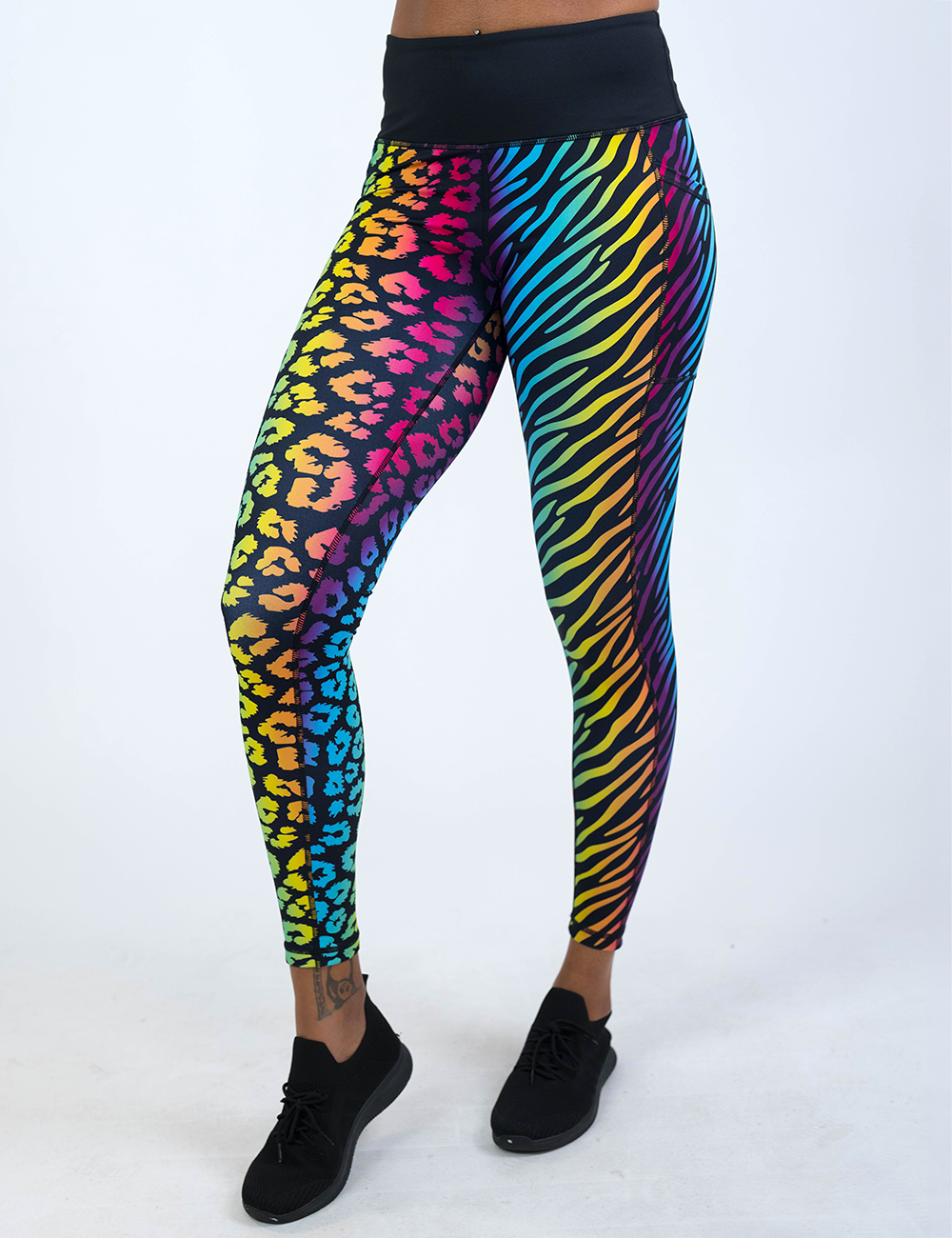 front of the full length zebra and leopard print rainbow leggings against a white background