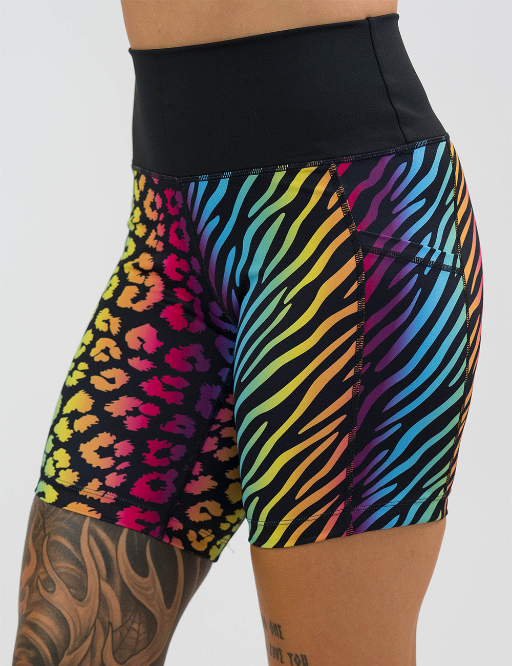 front of the 7 inch zebra and leopard rainbow print shorts against a white background