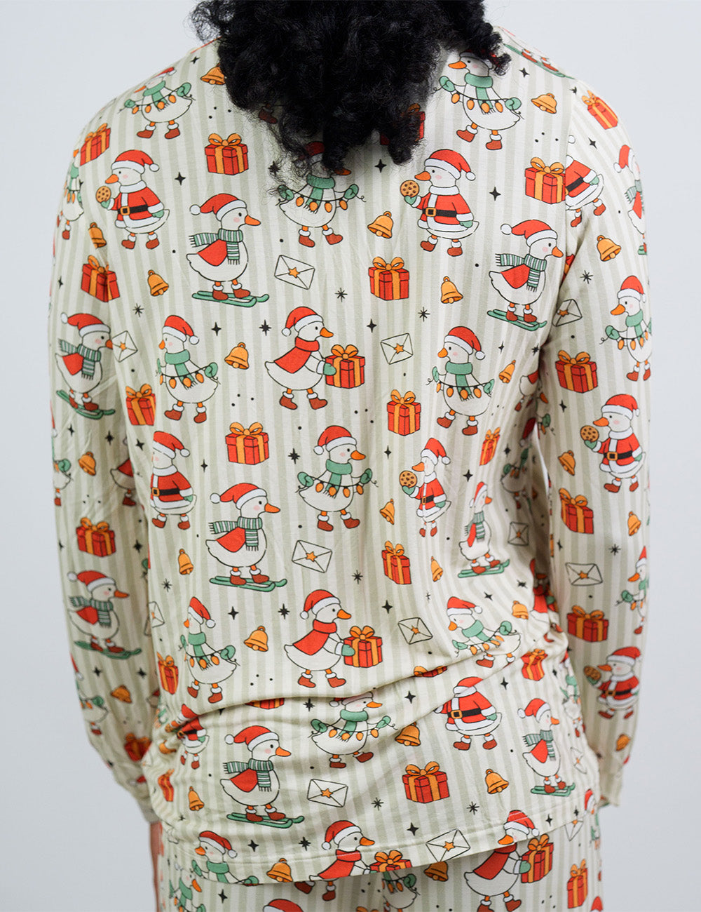 back of the ducks with santa hats surrounded by presents striped pajama top against a white background