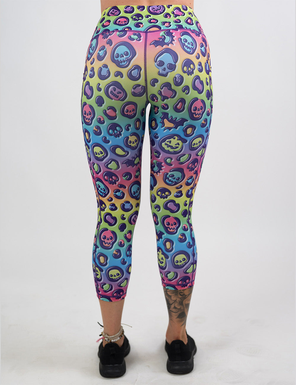back of the capri rainbow leopard print pumpkins and skulls leggings against a white background