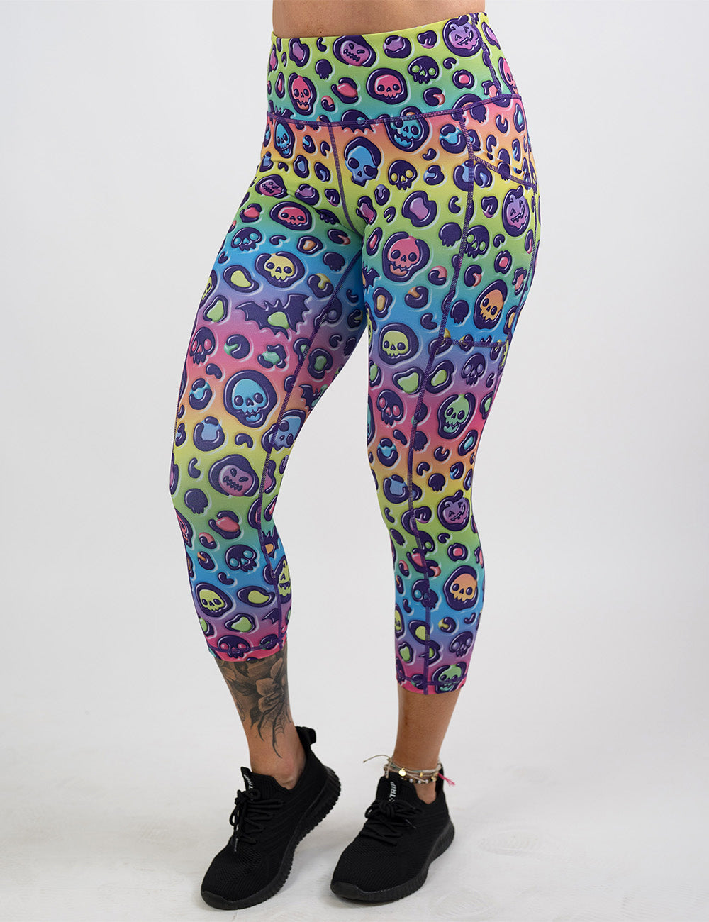 front of the rainbow leopard print pumpkins and skulls capri leggings against a white background
