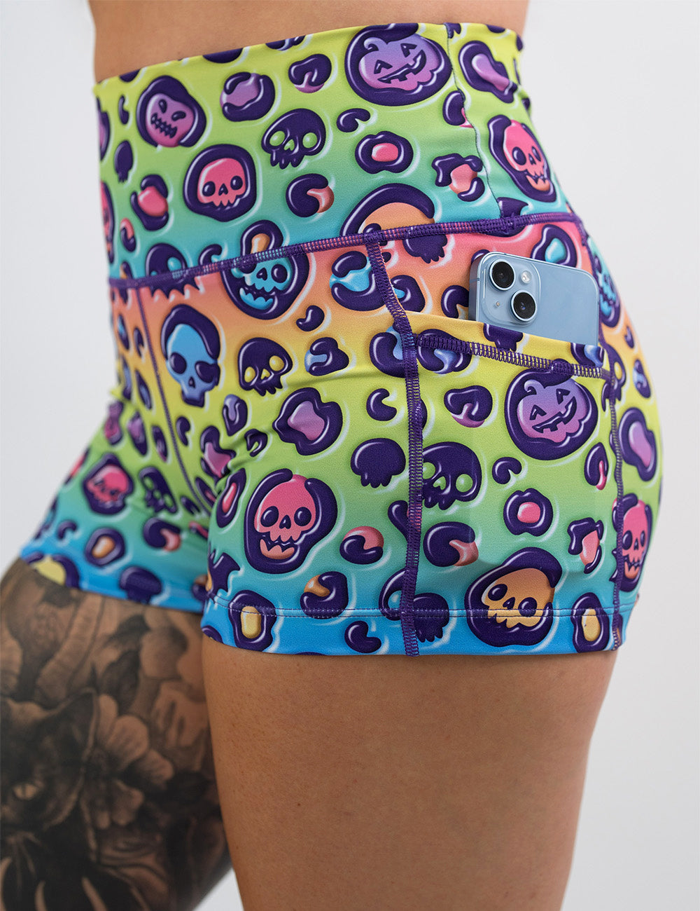 close up of the 2.5 inch rainbow leopard print pumpkins and skulls shorts against a white background
