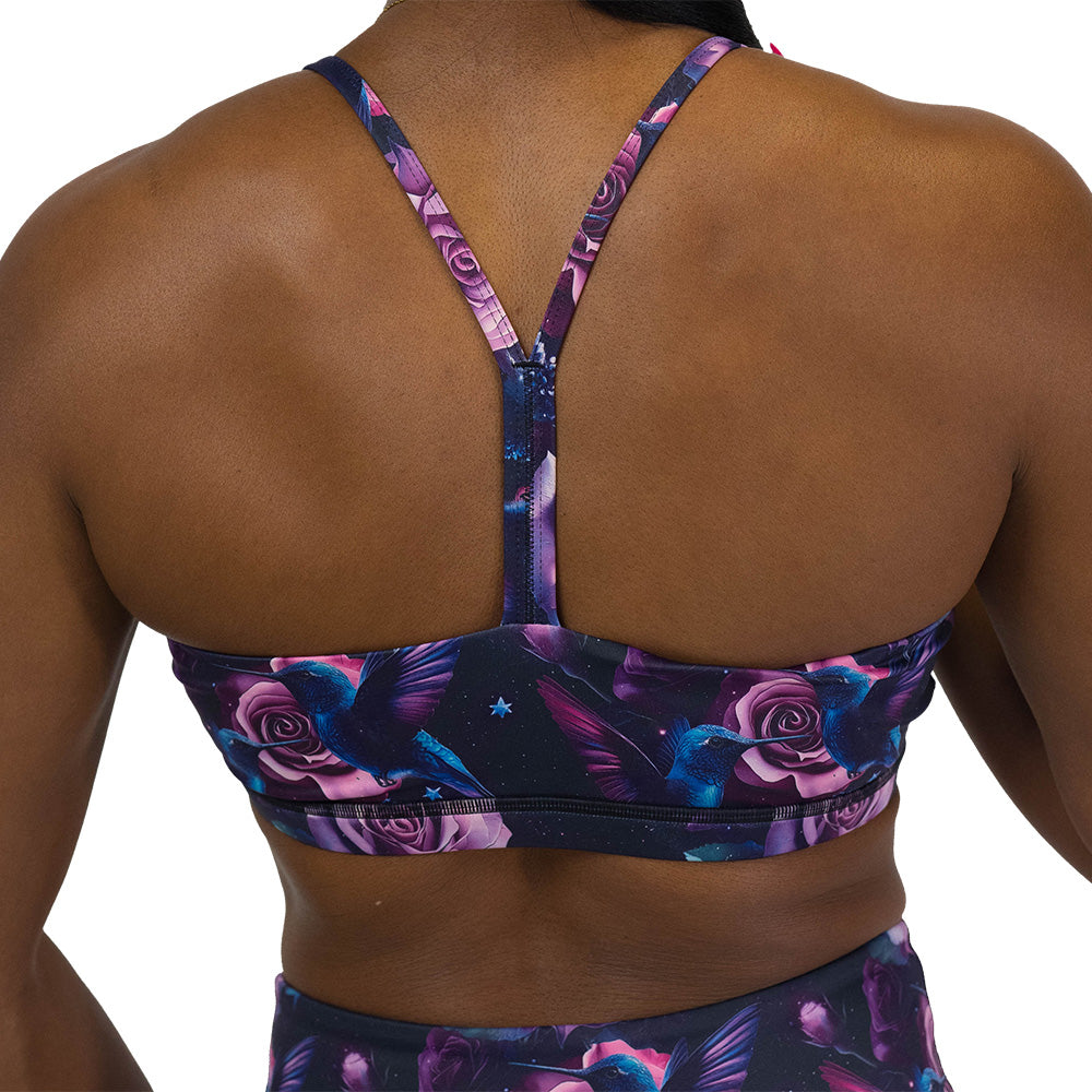back of the sports bra with a design of a blue hummingbird and pink roses