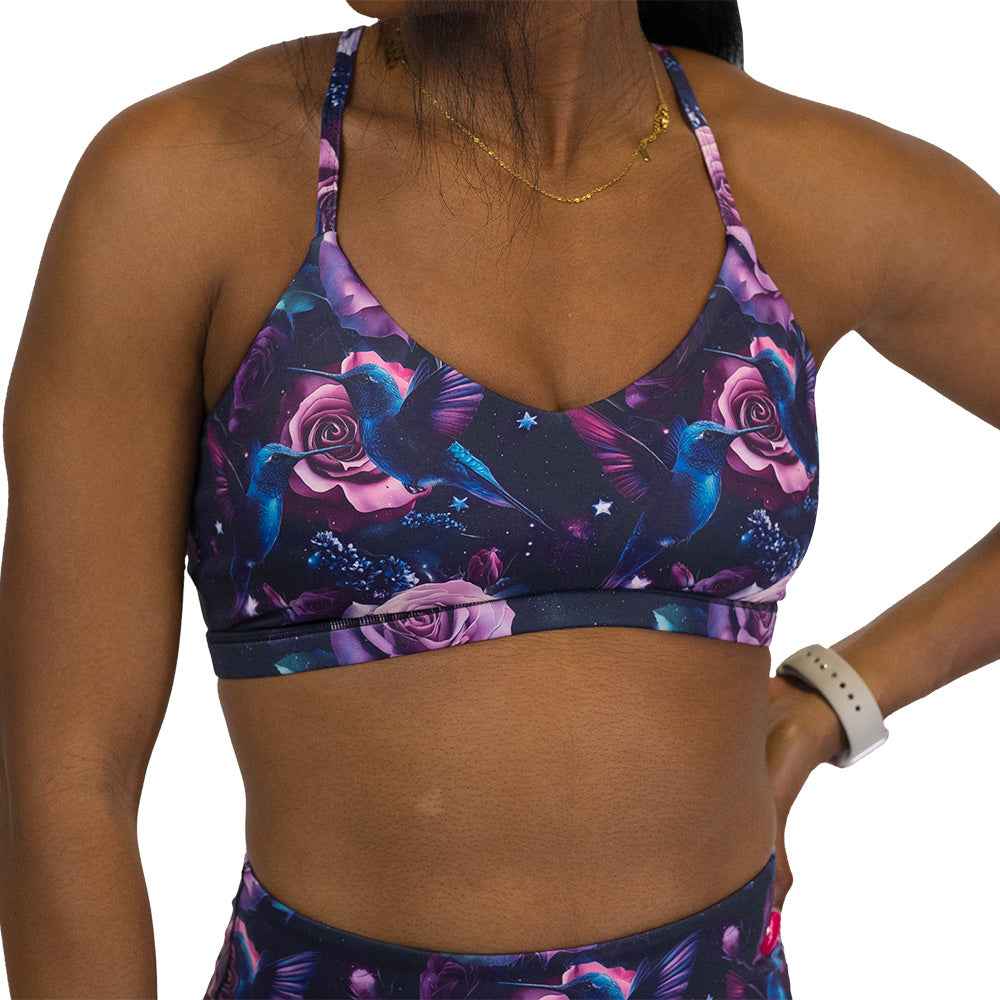 sports bra with a design of a blue hummingbird and pink roses