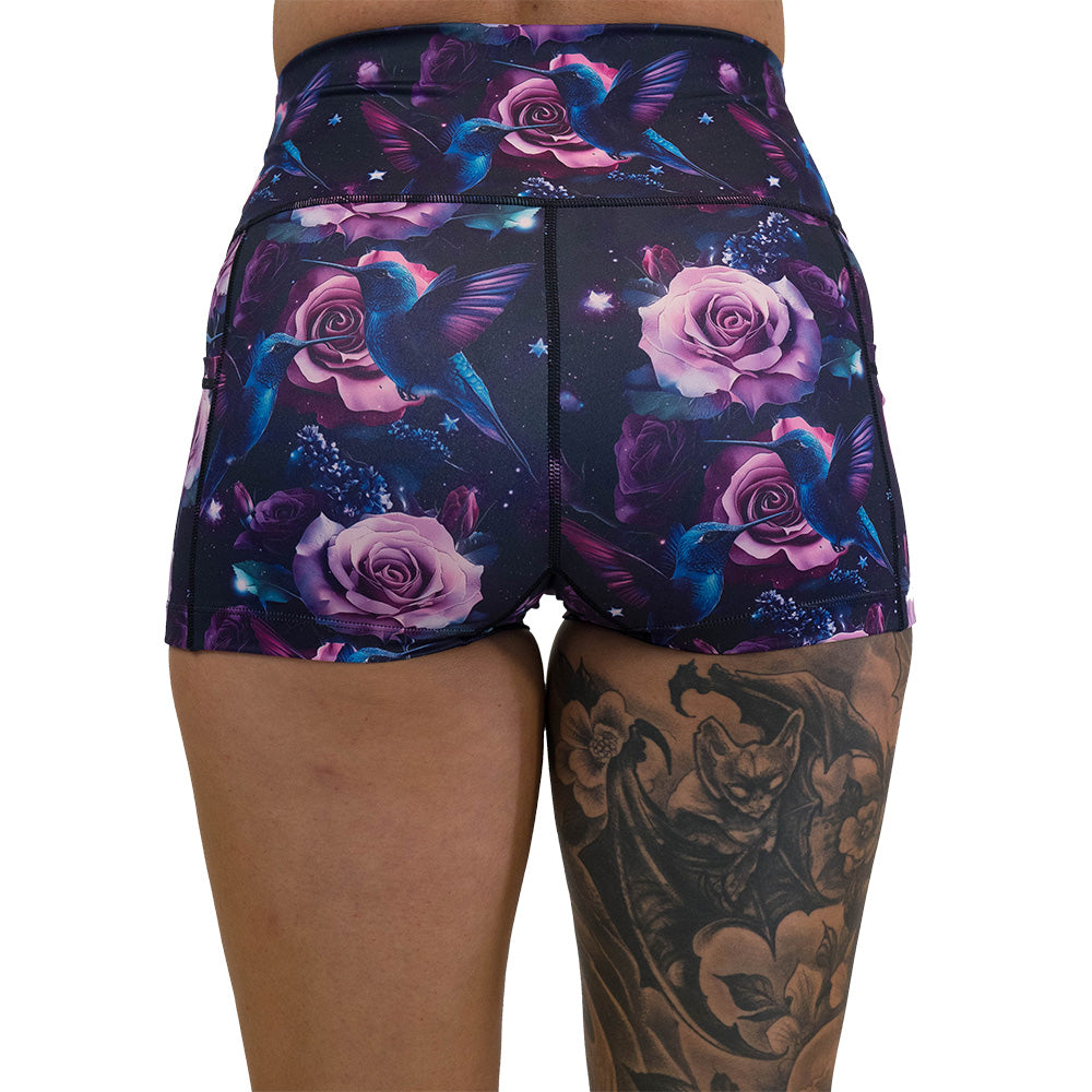 back of the shorts with a design of a blue hummingbird and pink roses
