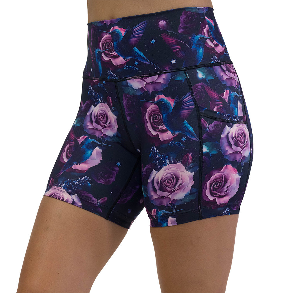 shorts with a design of a blue hummingbird and pink roses