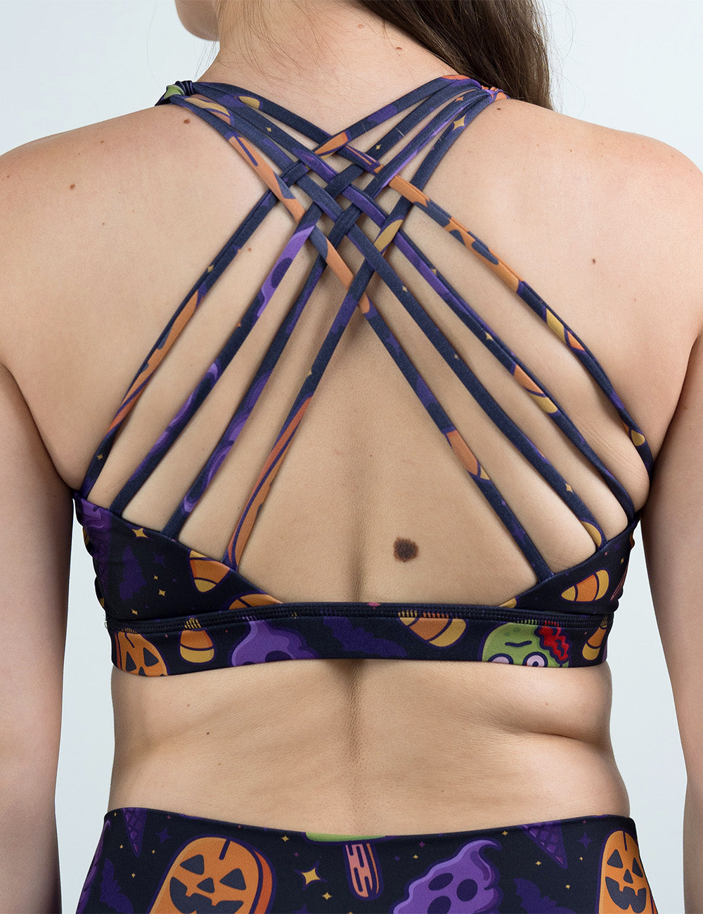 back of the zombie, jack o lantern, and ghost ice cream's sports bra against a white background