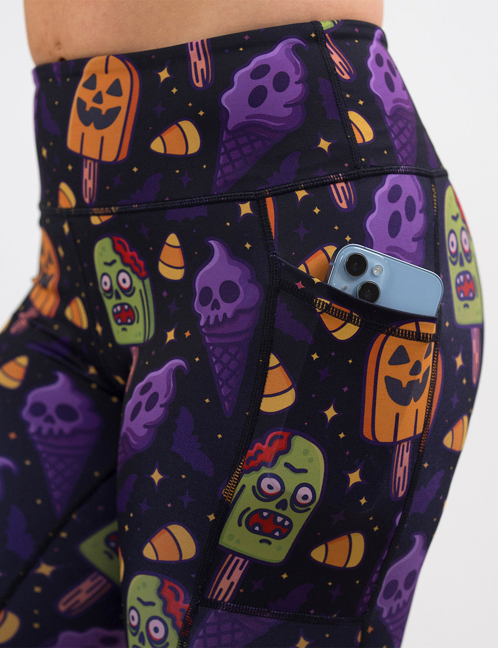 close up of the zombie, jack o lantern, and ghost ice cream's leggings with a phone in its pocket