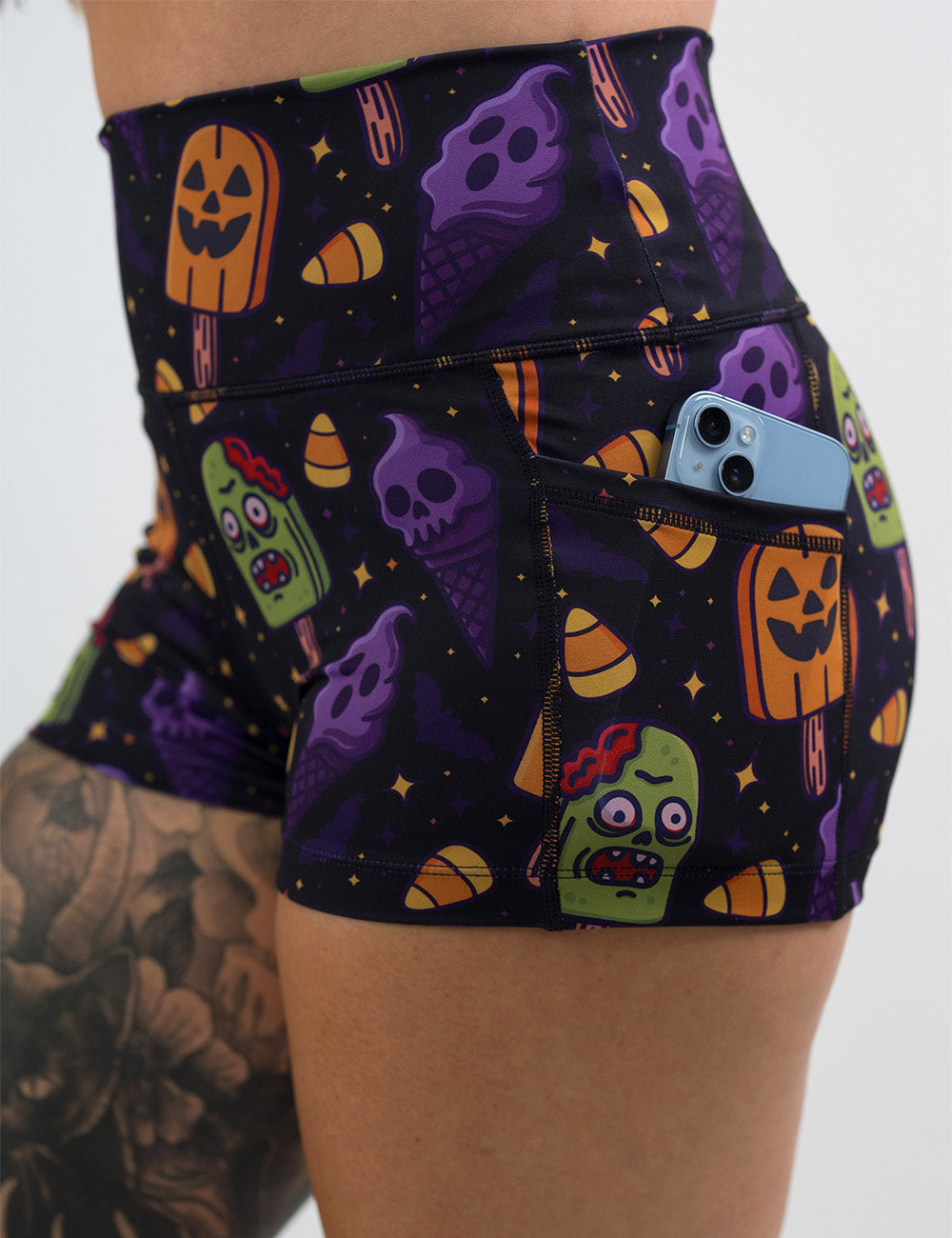 close up of the 2.5 inch zombie, jack o lantern, and ghost ice cream's shorts with a phone in its pocket