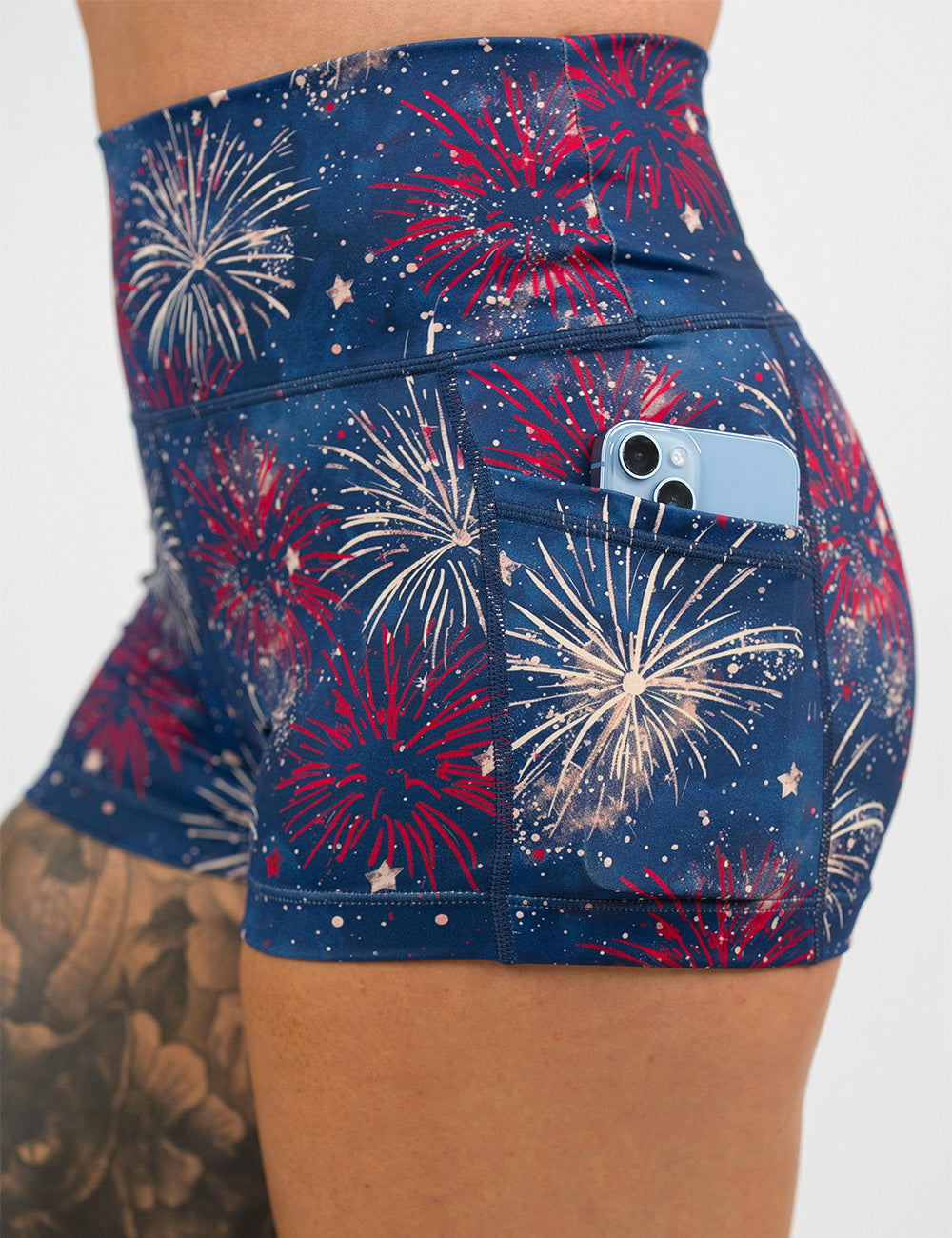 close up of the 2.5 inch patriotic fireworks shorts with a phone in its pocket