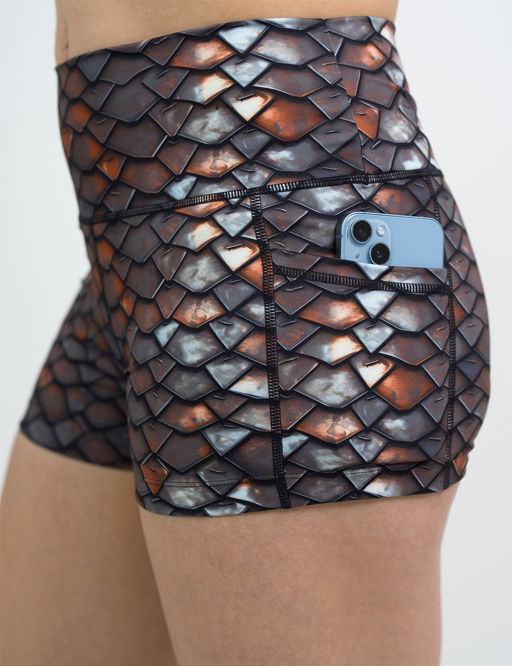 close up of the 2.5 inch iron scales pattern shorts with a phone in its pocket