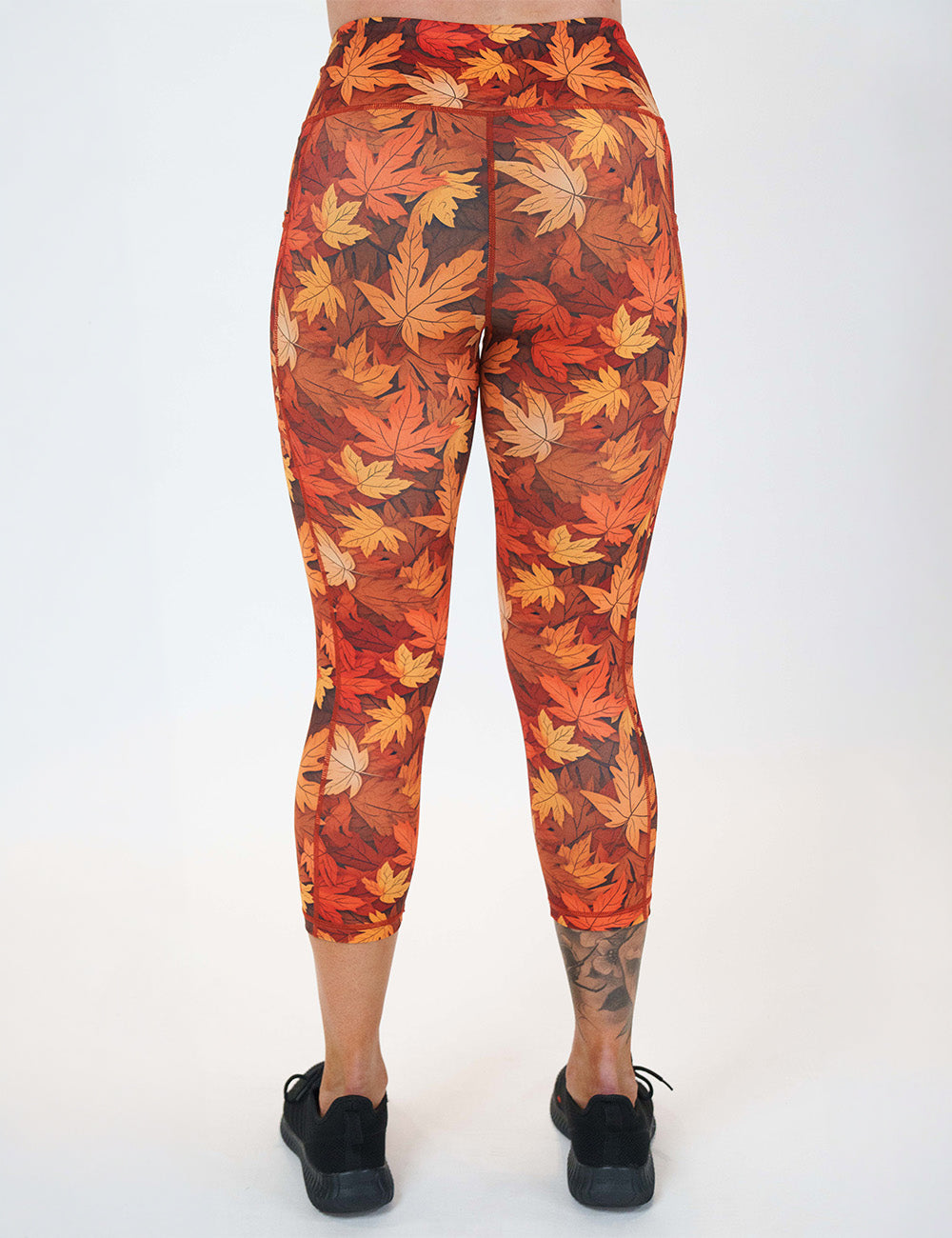 back of the orange leaves capri leggings against a white background