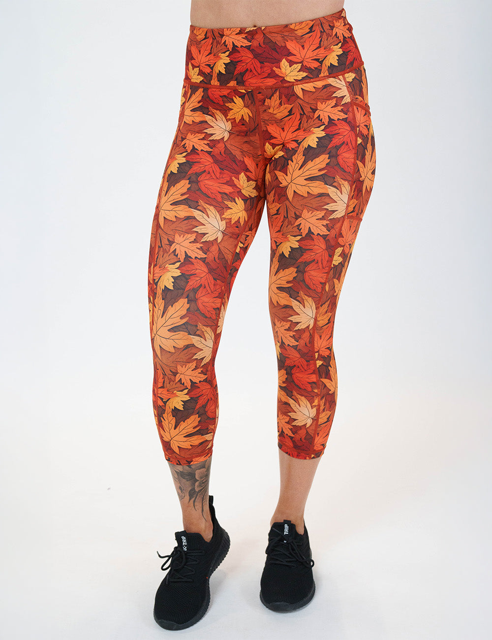 front of the orange leaves capri leggings against a white background