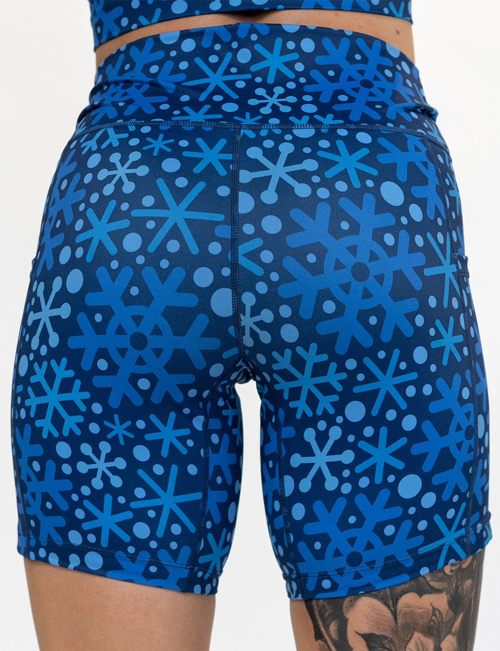 back of the blue snowflakes on a dark blue background 7 inch shorts against a white background