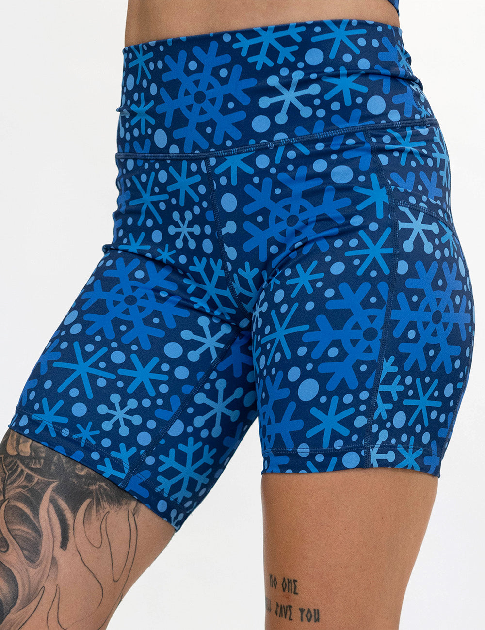 front of the 7 inch blue snowflakes on a dark blue background shorts against a white background