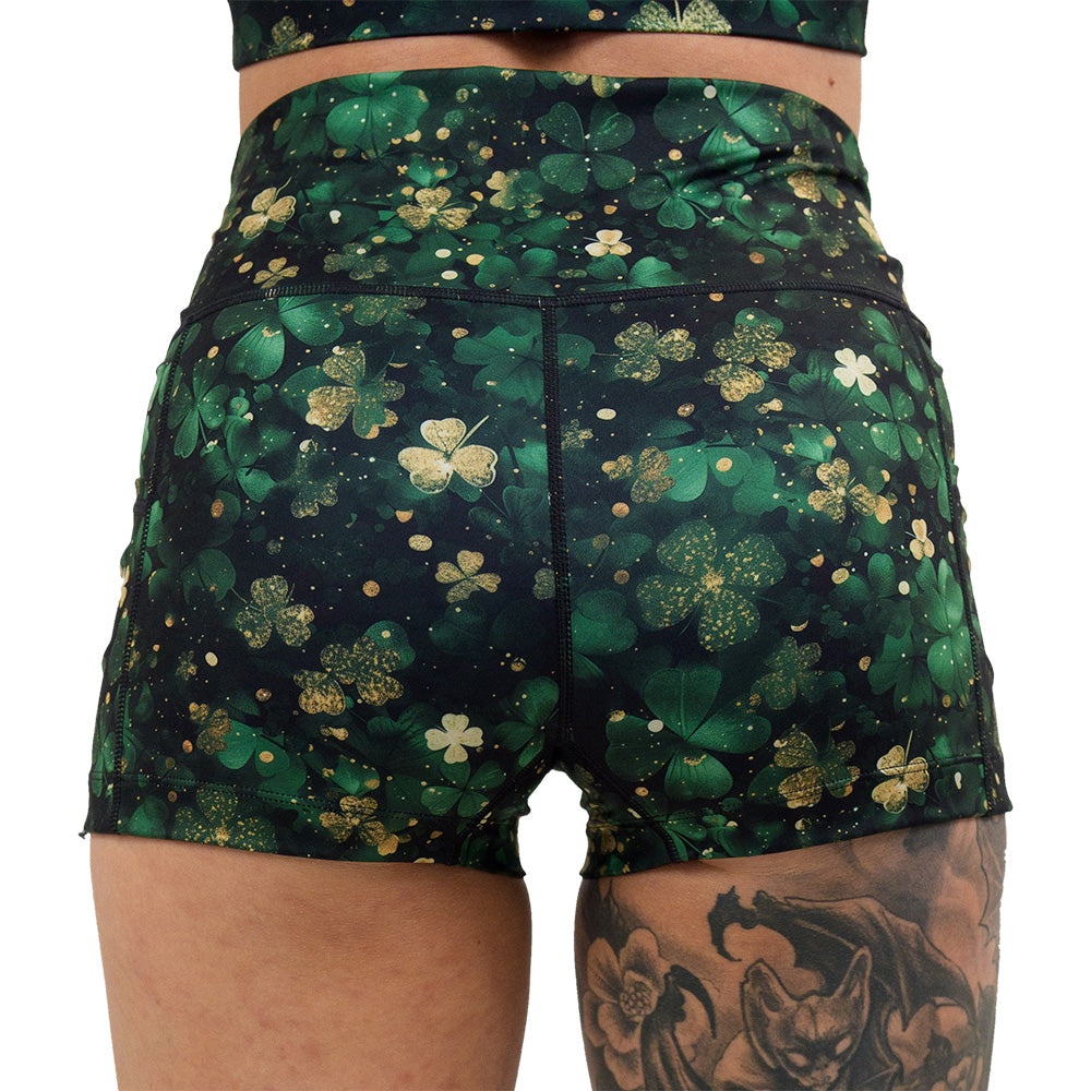 back of the 2.5 inch green and gold shamrock patterned shorts against a white background