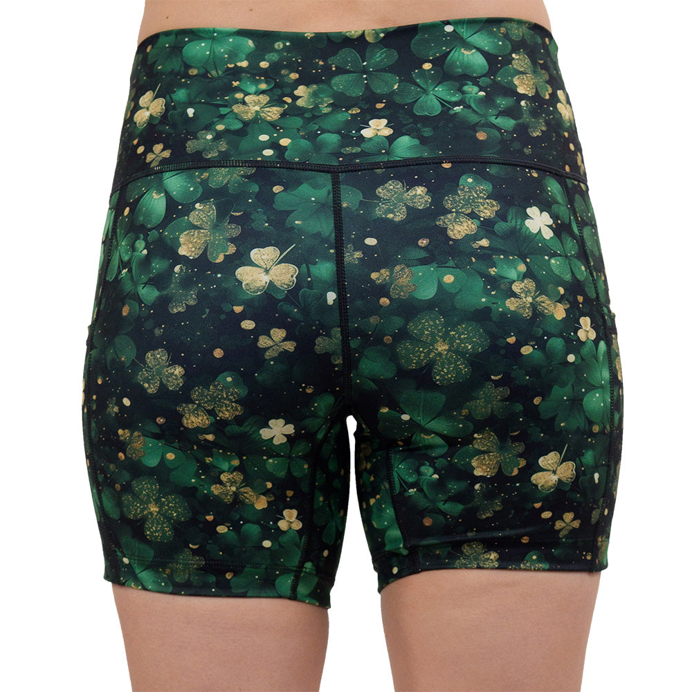back of the 5 inch green and gold shamrock patterned shorts against a white background