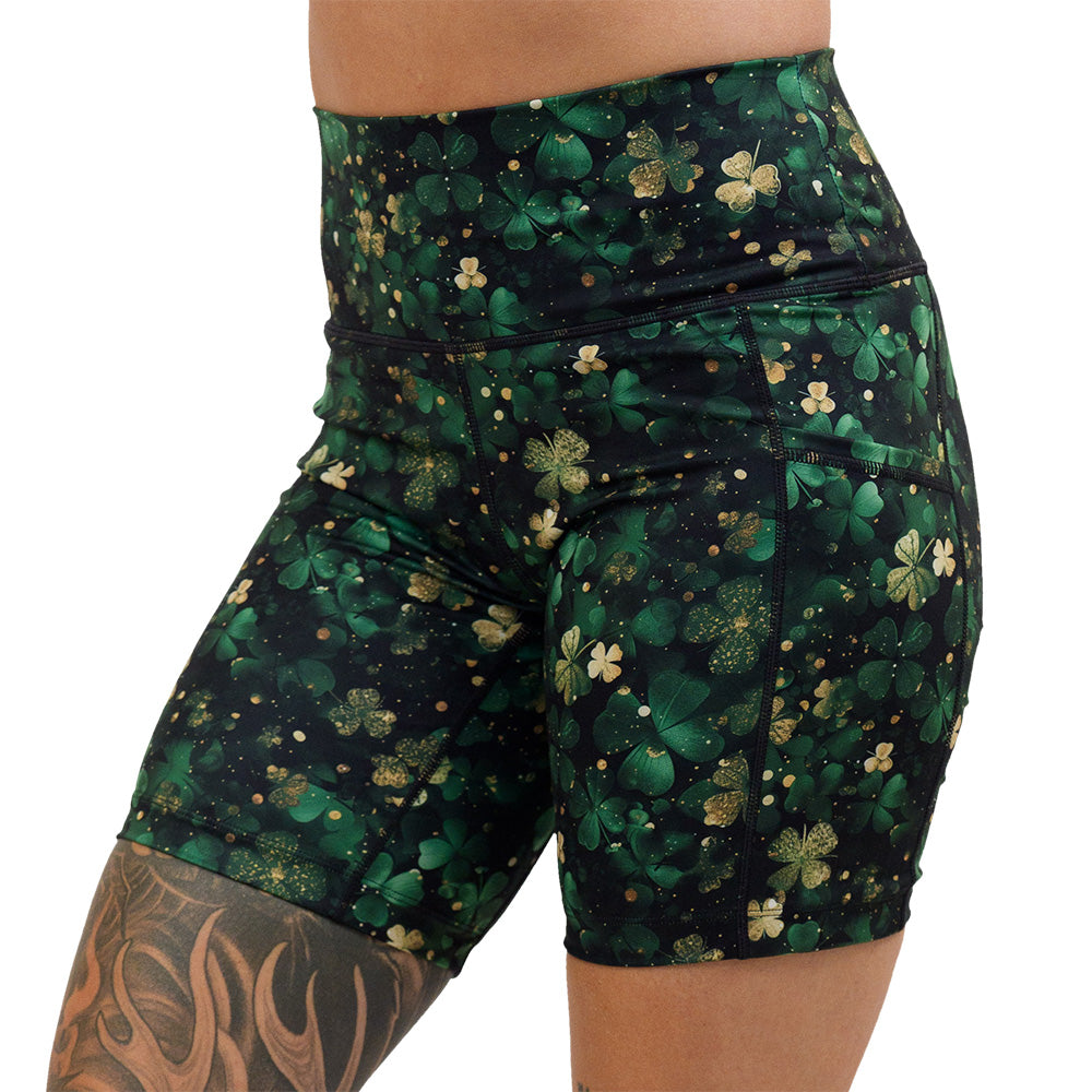 7 inch green and gold shamrock patterned shorts facing the front against a white background