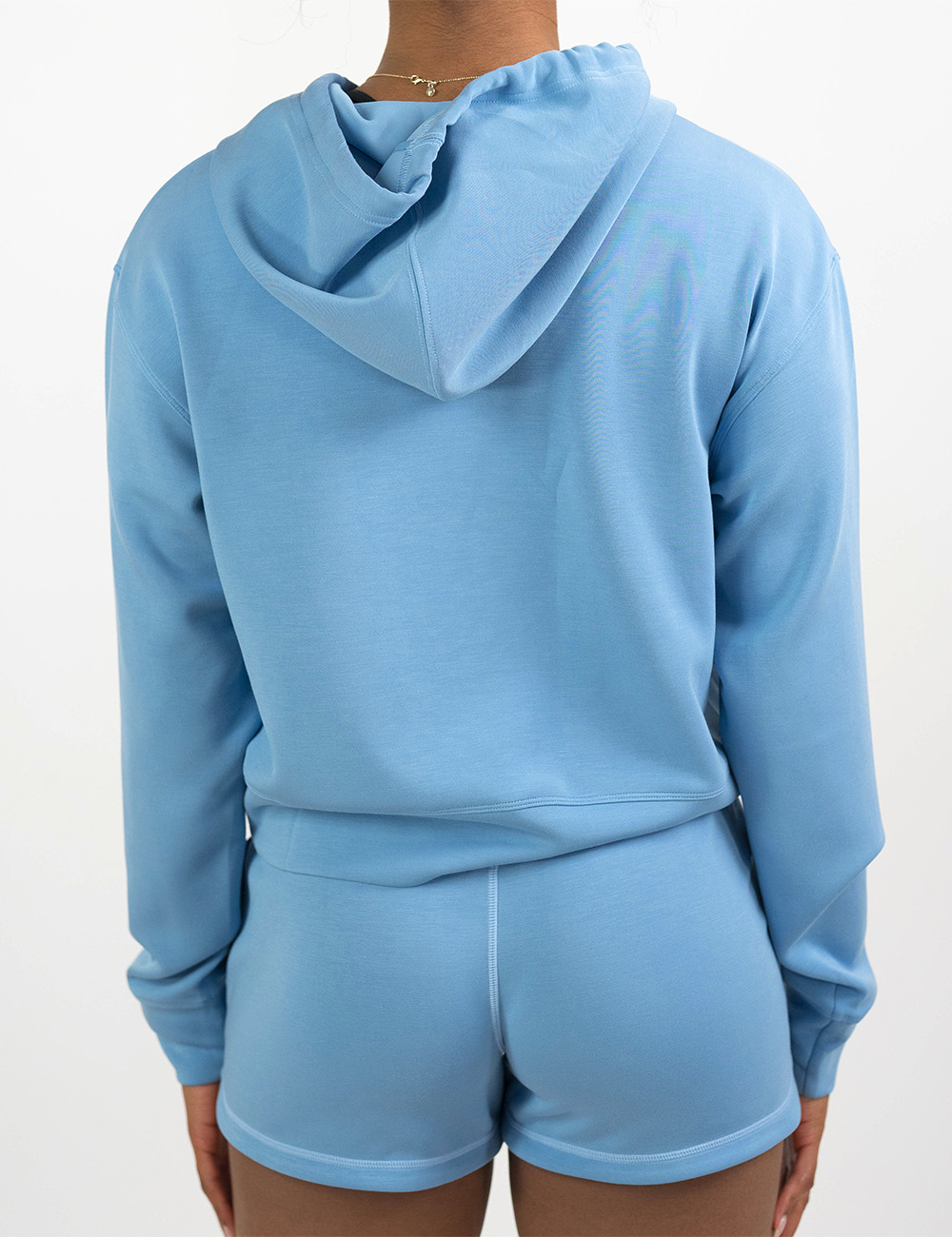 back of the light blue sweatshirt against a white background