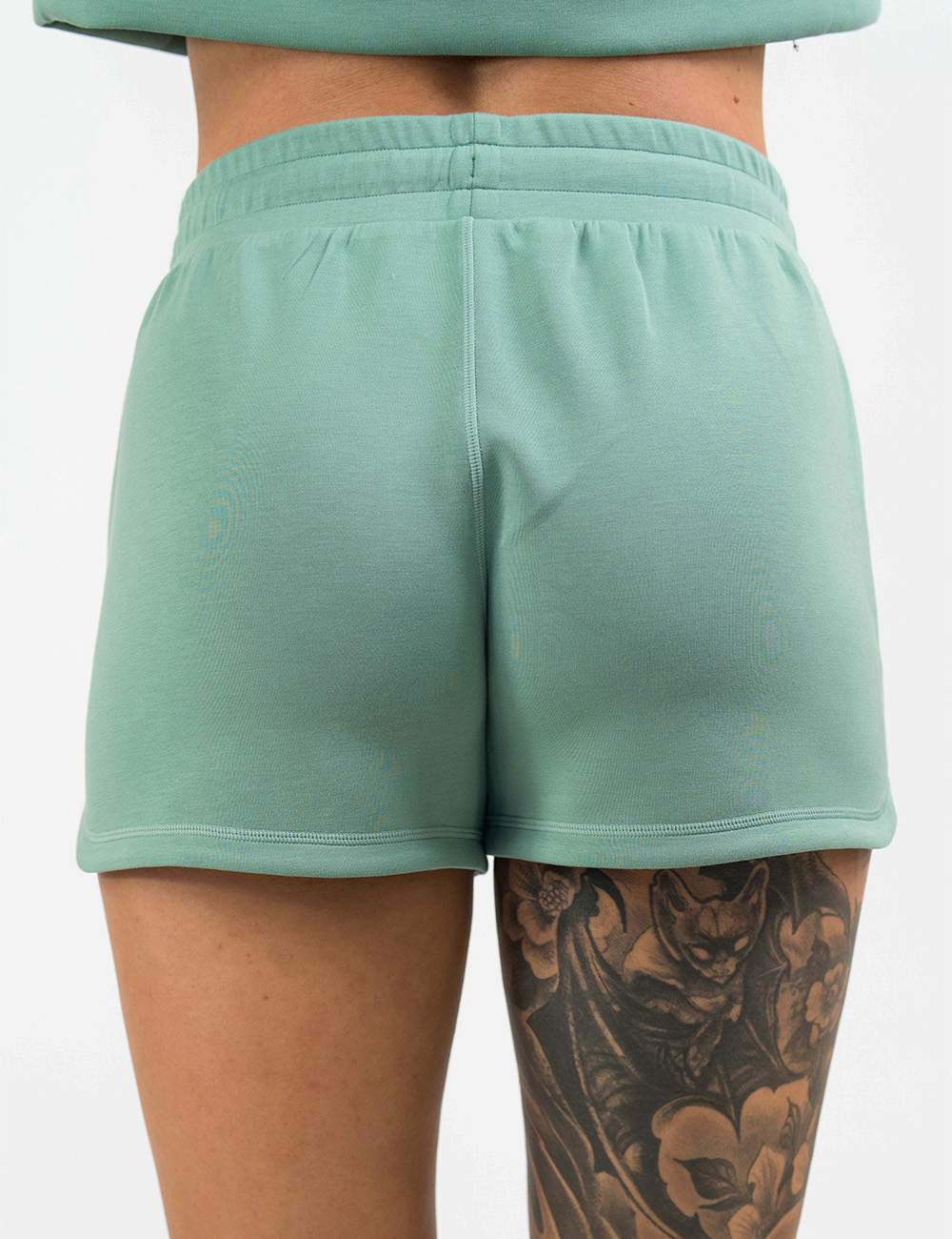 back of the light green draw string shorts against a white background