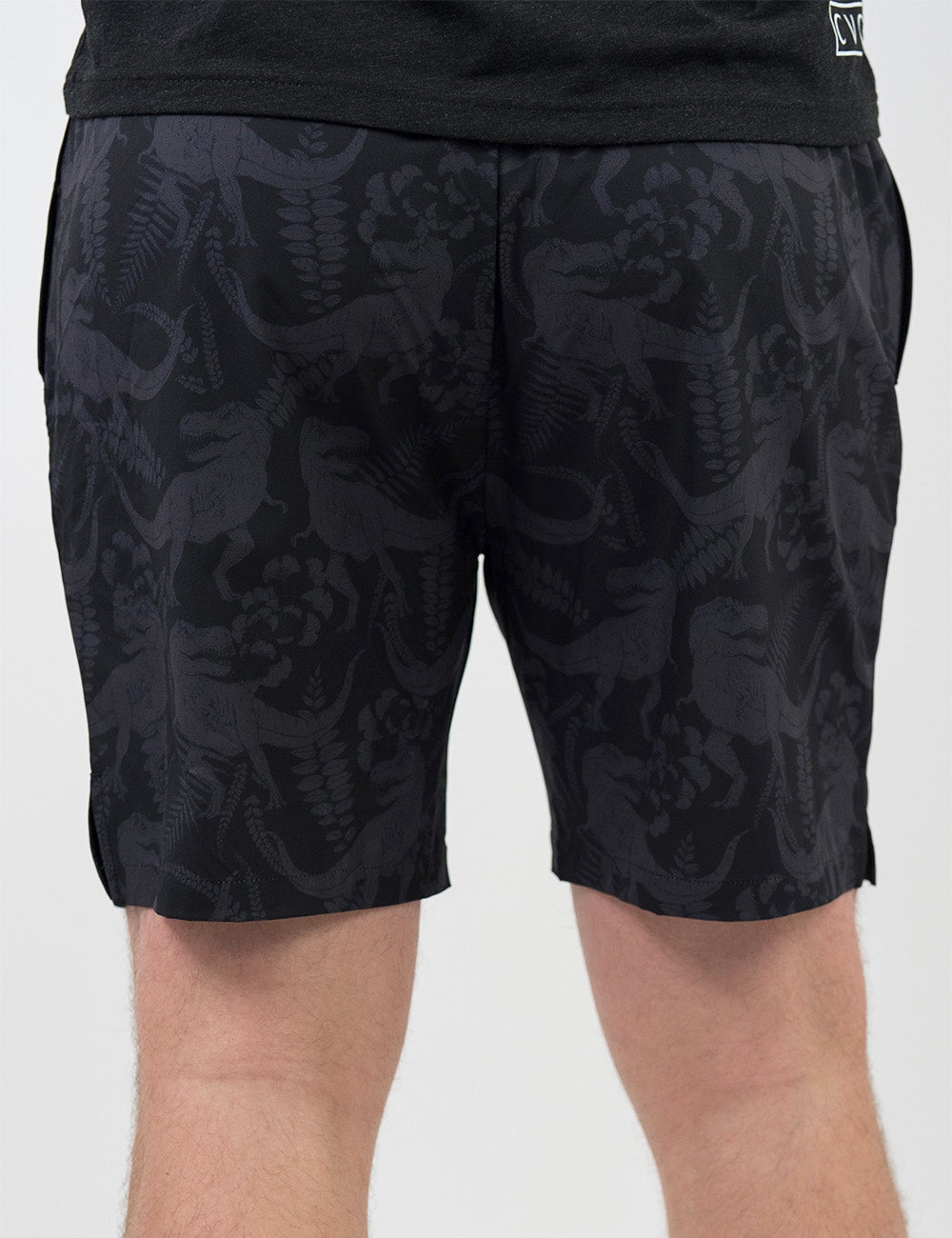 back of the black men's shorts with a tonal grey t-rex pattern against a white background
