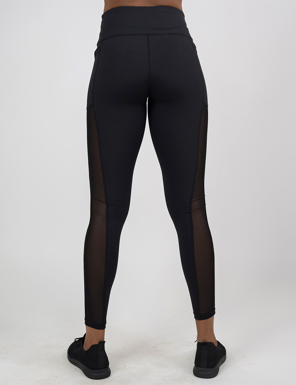 back of the full length black mesh leggings against a white background