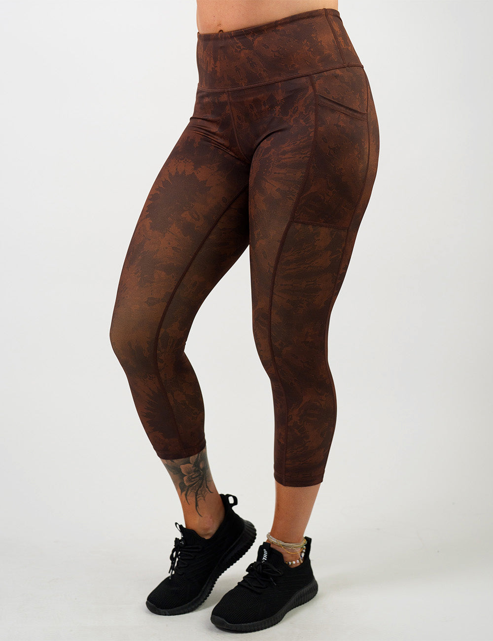 front of the brown tie dye capri leggings against a white background