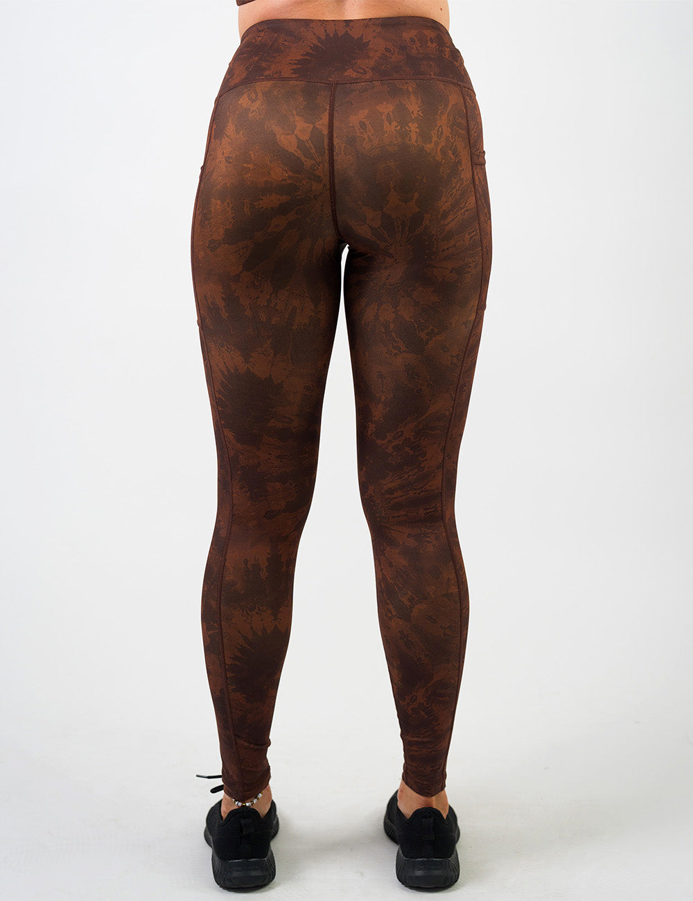 back of the brown tie dye full length leggings against a white background