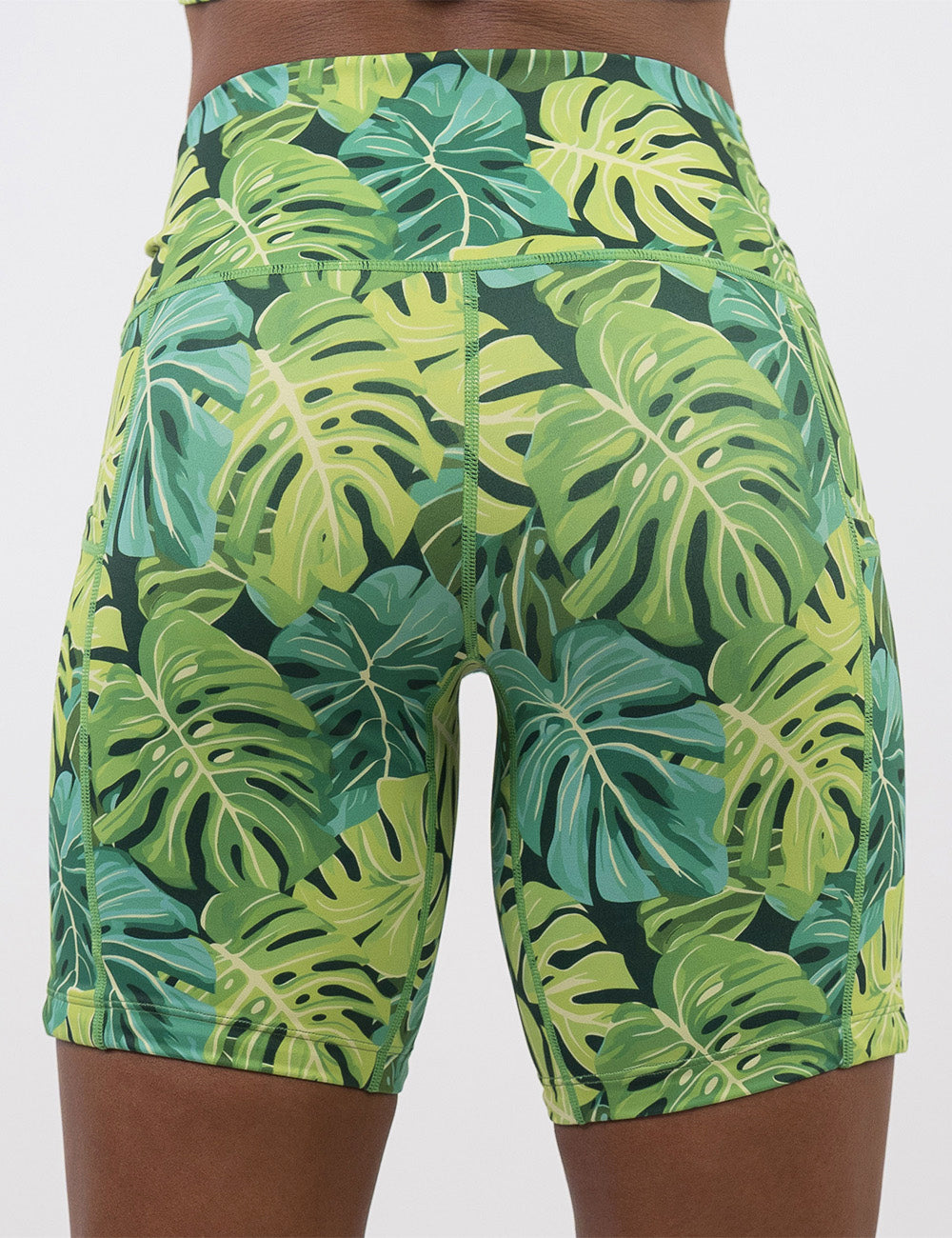 back of the 7 inch green tropical leaves shorts against a white background