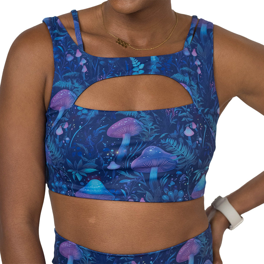 sports bra with a blue and purple mushroom and foliage design on a white background