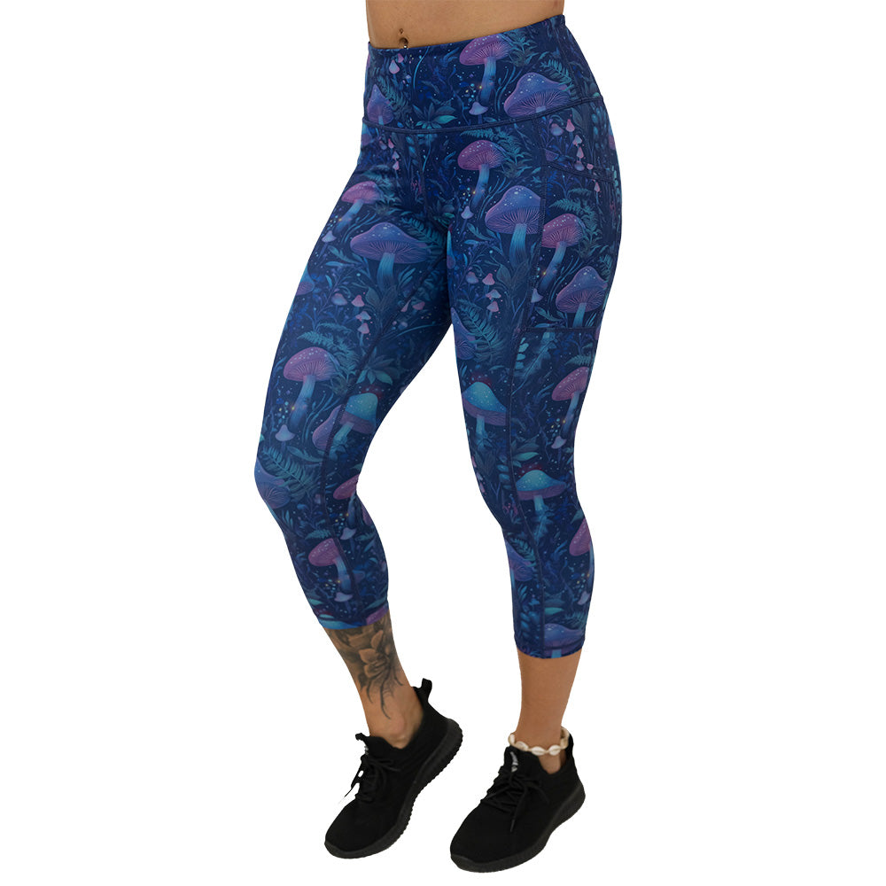 leggings with a blue and purple mushroom and foliage design on a white background