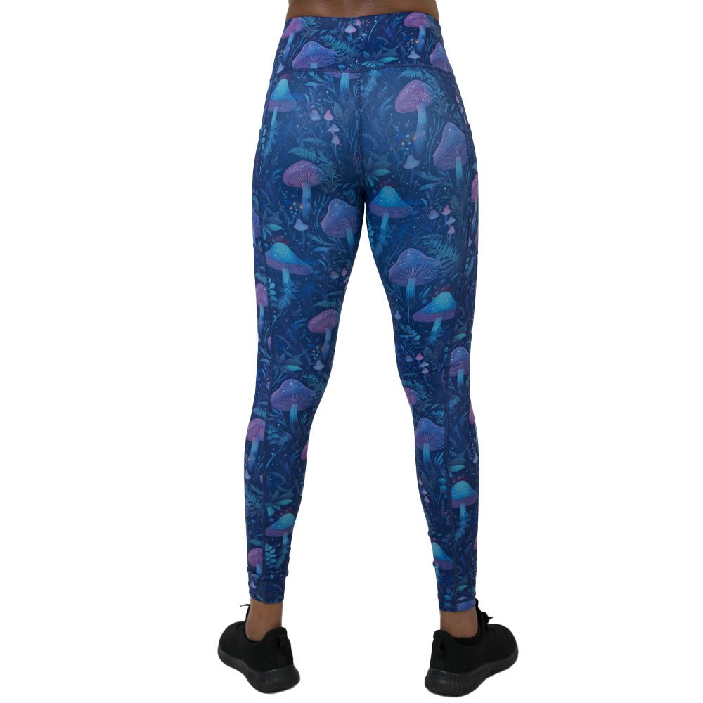 back of the leggings with a blue and purple mushroom and foliage design on a white background
