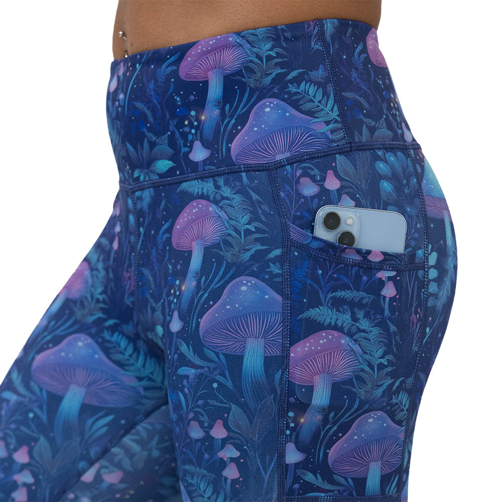 leggings with a blue and purple mushroom and foliage design on a white background