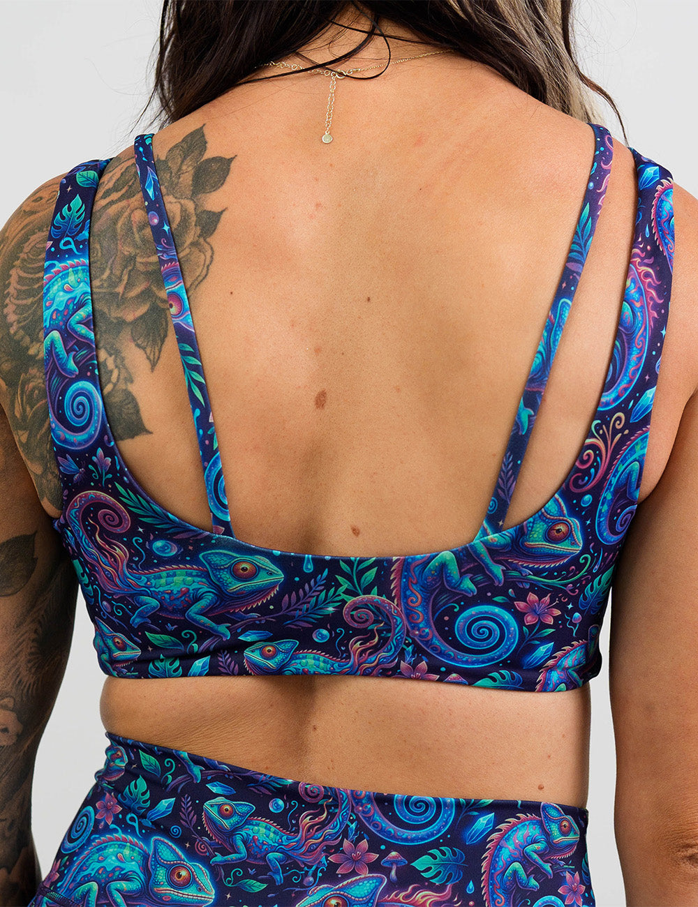back of the orange, blue, and red chameleons sports bra against a white background
