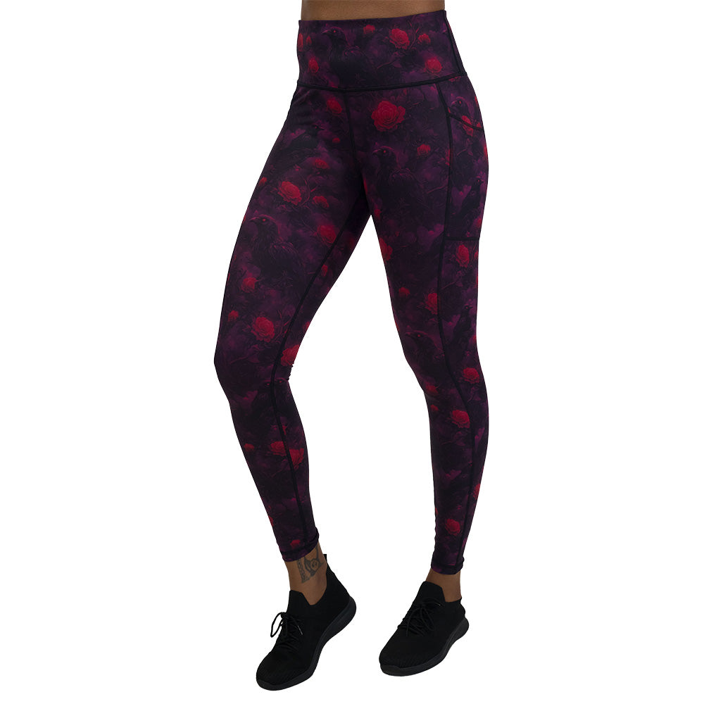 Black leggings with red floral and crow pattern on it