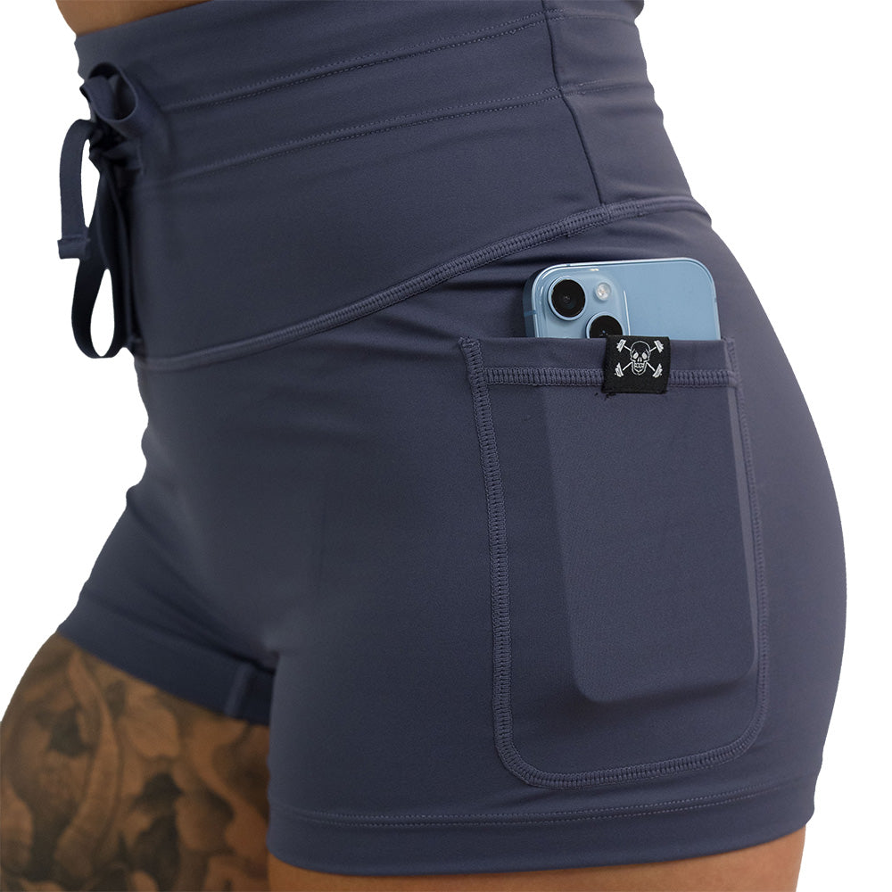 close up of the 2.5 inch omni twilight purple shorts with a phone in the pocket