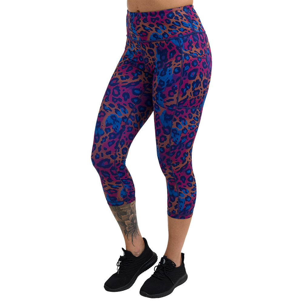 cheetah print against a yellow, blue, and purple background pattern capri leggings facing the front against a white background