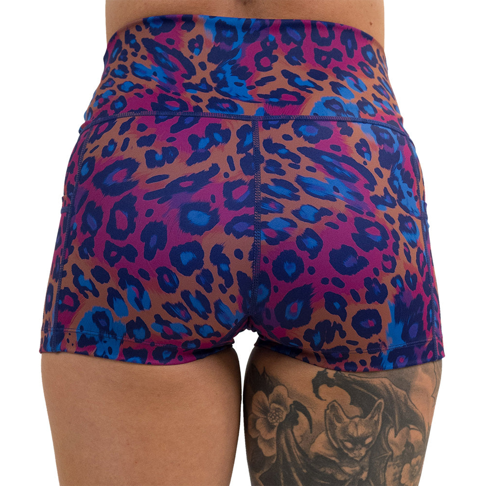 back of the 2.5 inch cheetah print against a yellow, blue, and purple background pattern shorts