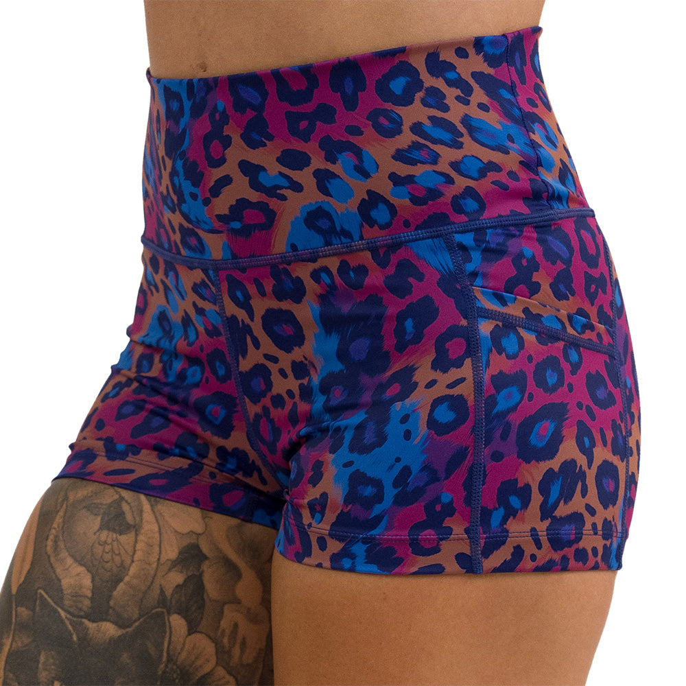 close up of the cheetah print against a yellow, blue, and purple background pattern 2.5 inch shorts against a white background