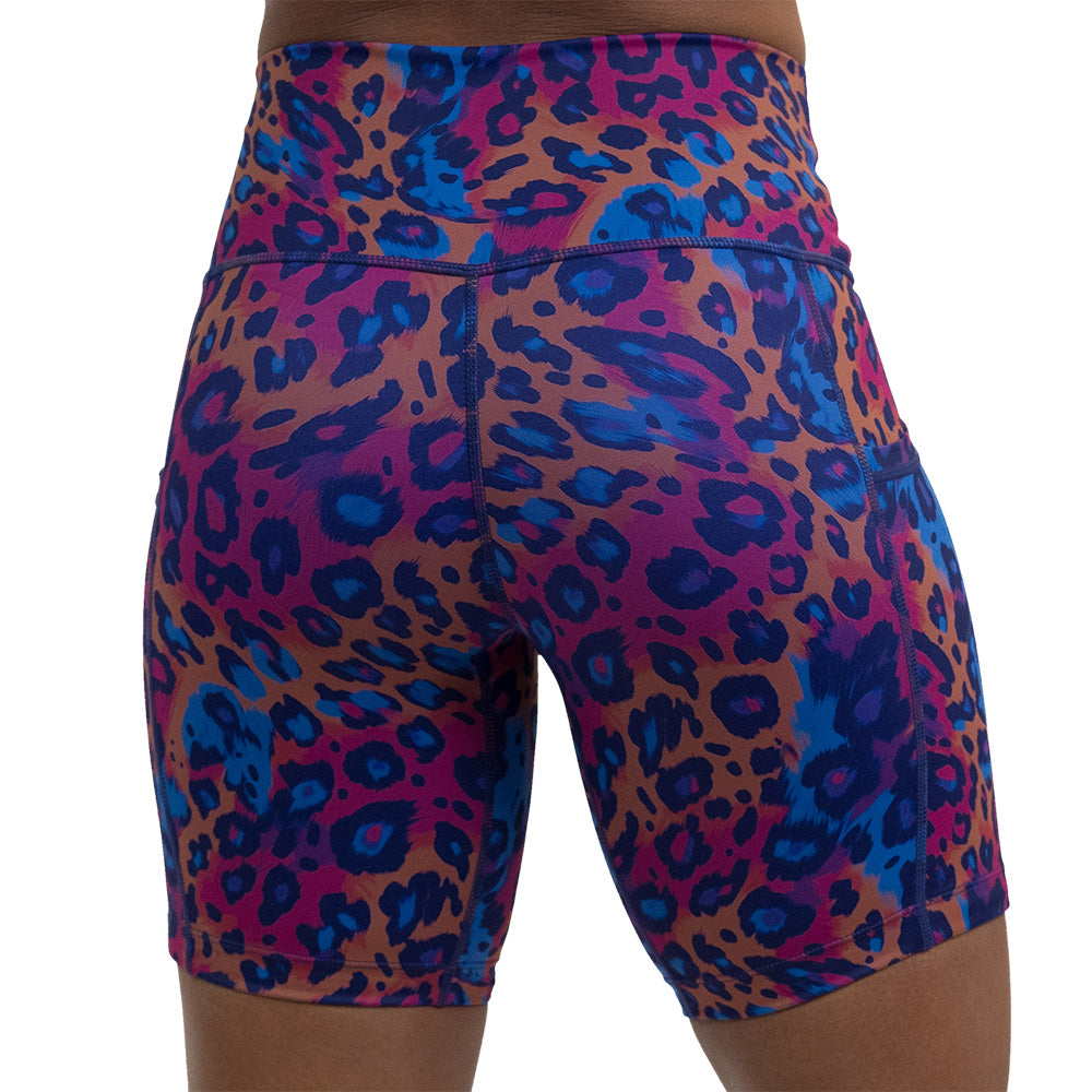 back of the 7 inch cheetah print against a yellow, blue, and purple background pattern shorts against a white background