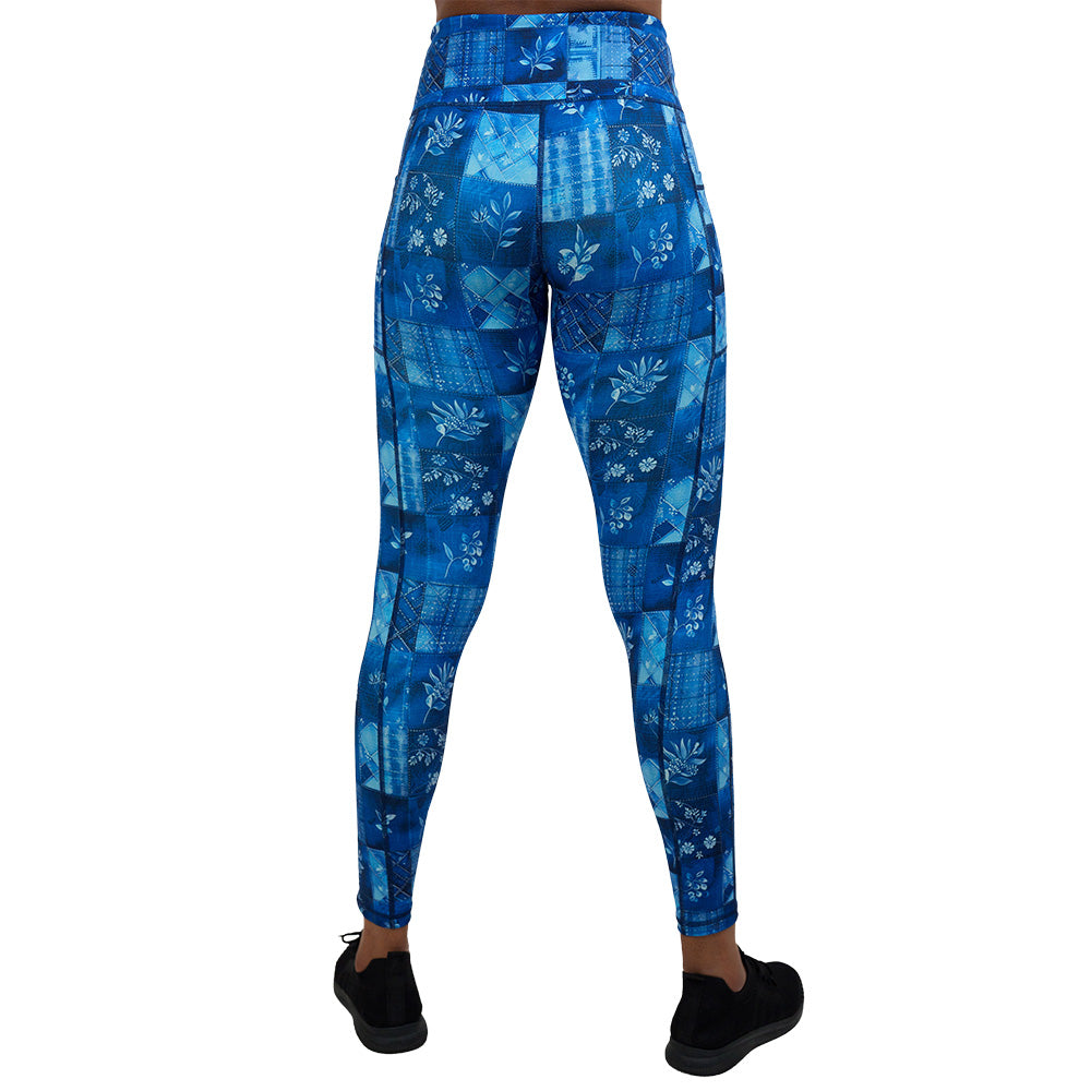 back of the blue patch work pattern with plant designs full length leggings against a white background