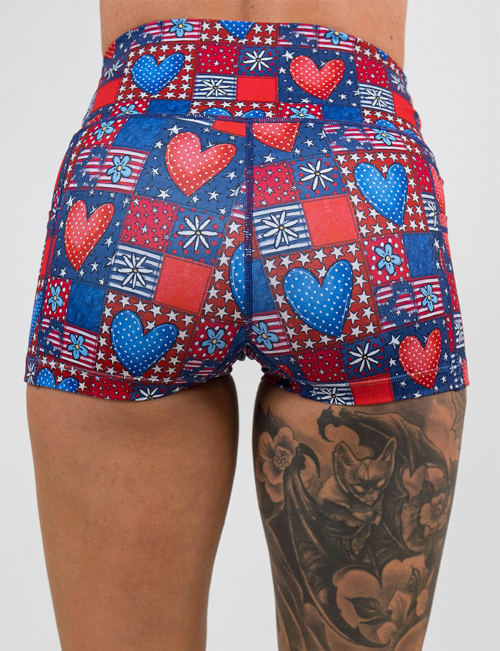 back of the 2.5 inch patchwork american flag with red and blue hearts pattern shorts against a white background