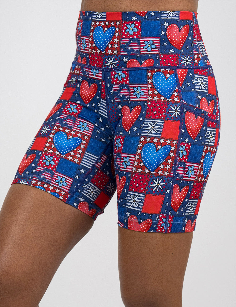 front of the 7 inch patchwork american flag with red and blue hearts pattern shorts against a white background