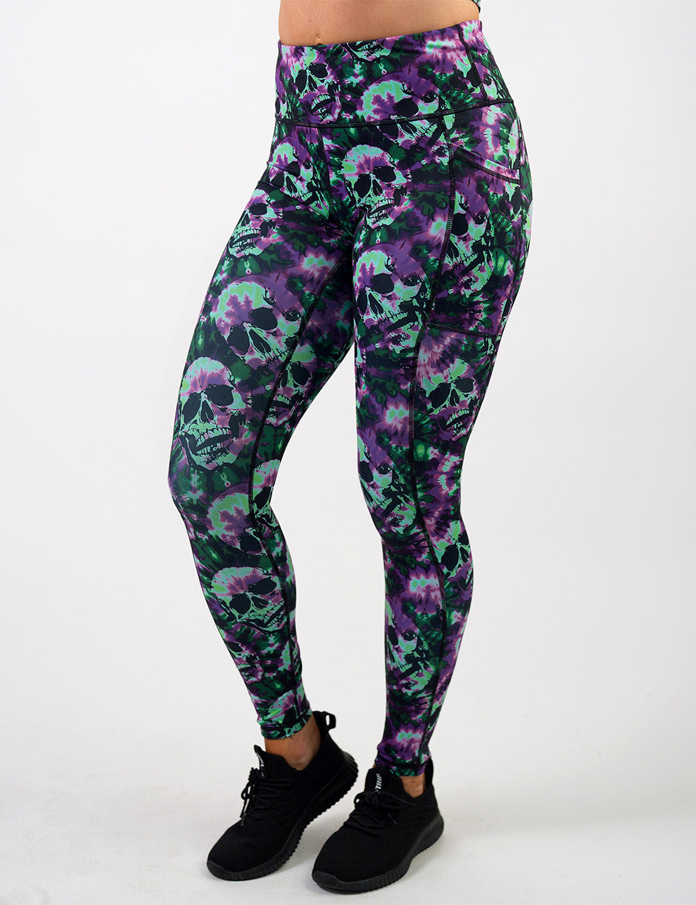 front of the purple and green tie dye skulls full length leggings against a white background