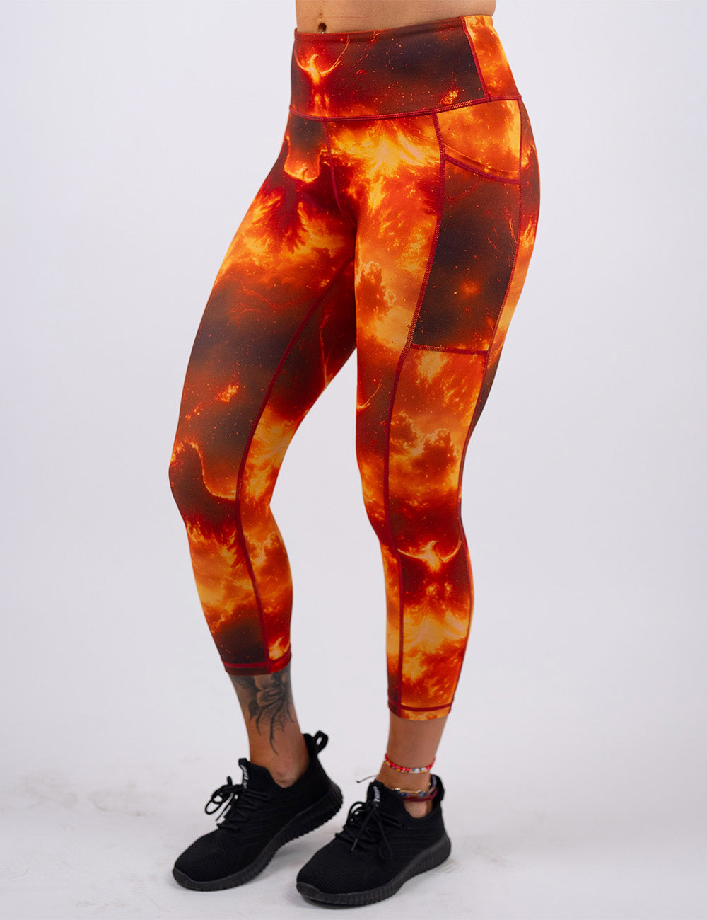 front of the phoenix surrounded by fire capri leggings against a white background