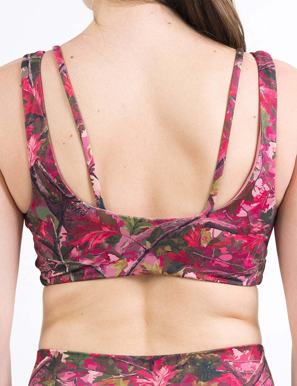 back of the pink forest camo vista bra against a white background